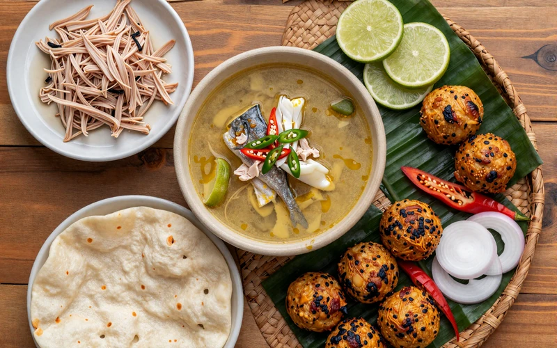 Authentic Maldivian cuisine spread featuring garudhiya fish broth, mas huni, roshi flatbread, and traditional hedhikaa short-eats
